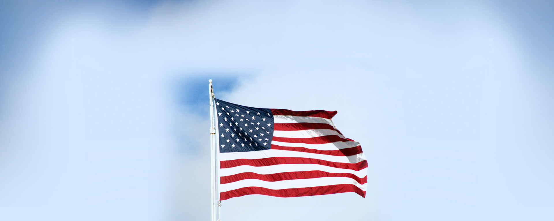 Hoisted U.S Flag flying in sky