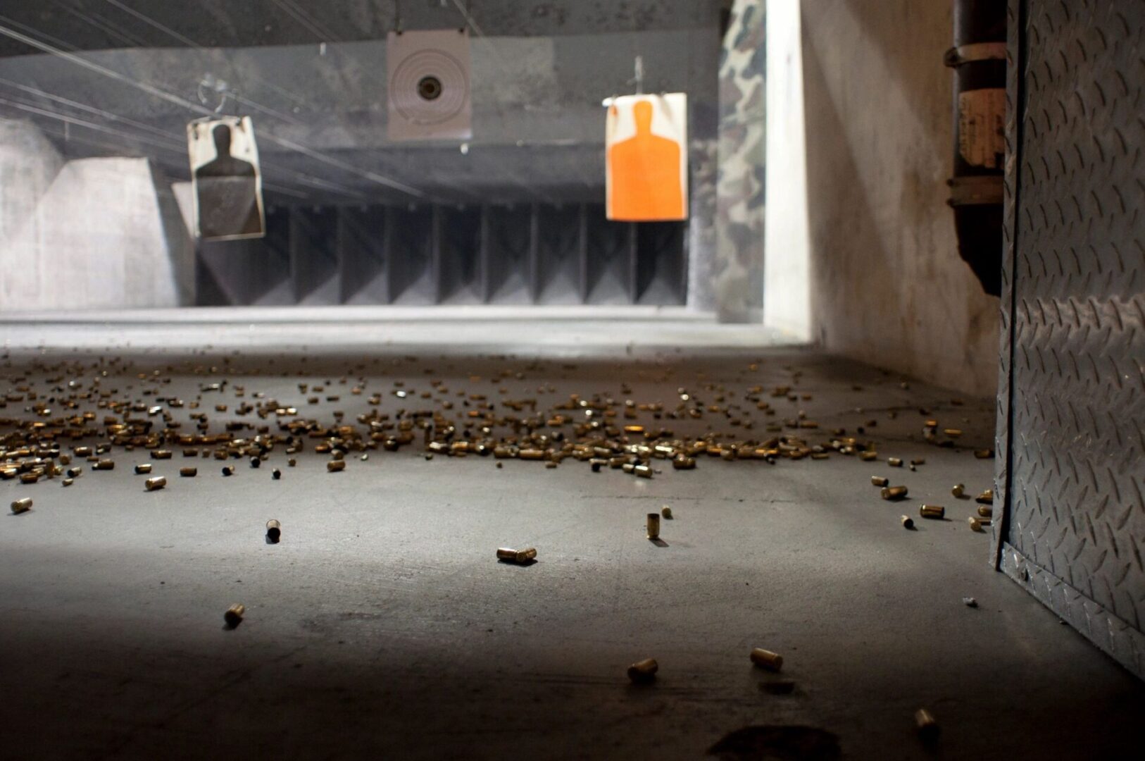 A lot of bullet shells on the floor in a target practice